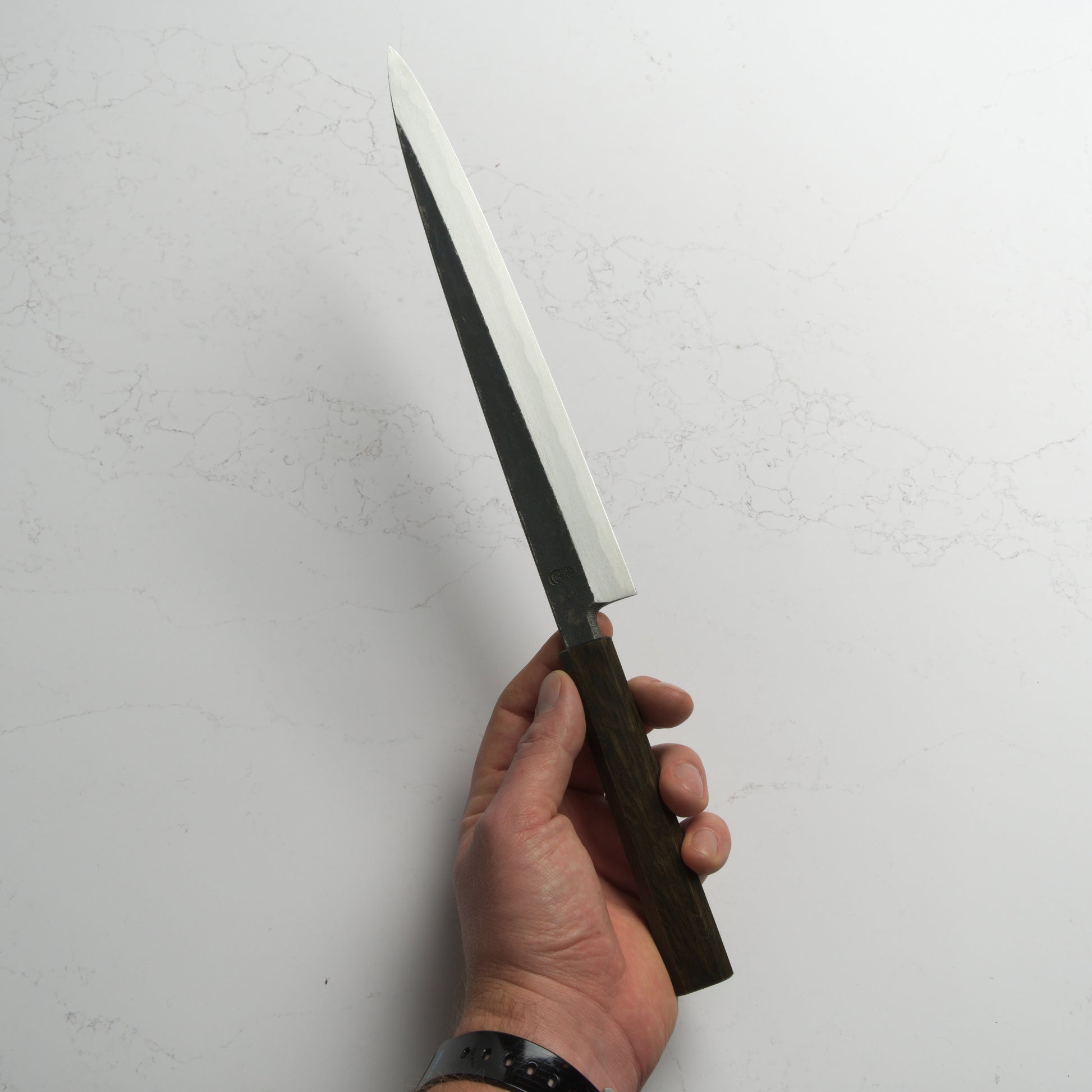 Sakai Kikumori Kikuzuki Kuro Yanagiba 270mm – Traditional carbon steel Japanese sushi knife with a kurouchi finish and octagonal handle. Handcrafted in Sakai, Japan. Available at Blade & Board.