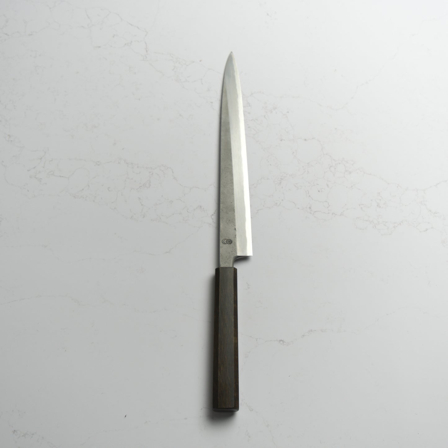 Sakai Kikumori Kikuzuki Rin Yanagiba 270mm – Hand-forged carbon steel sushi knife with ebony handle, crafted in Sakai, Japan. Available at Blade & Board.